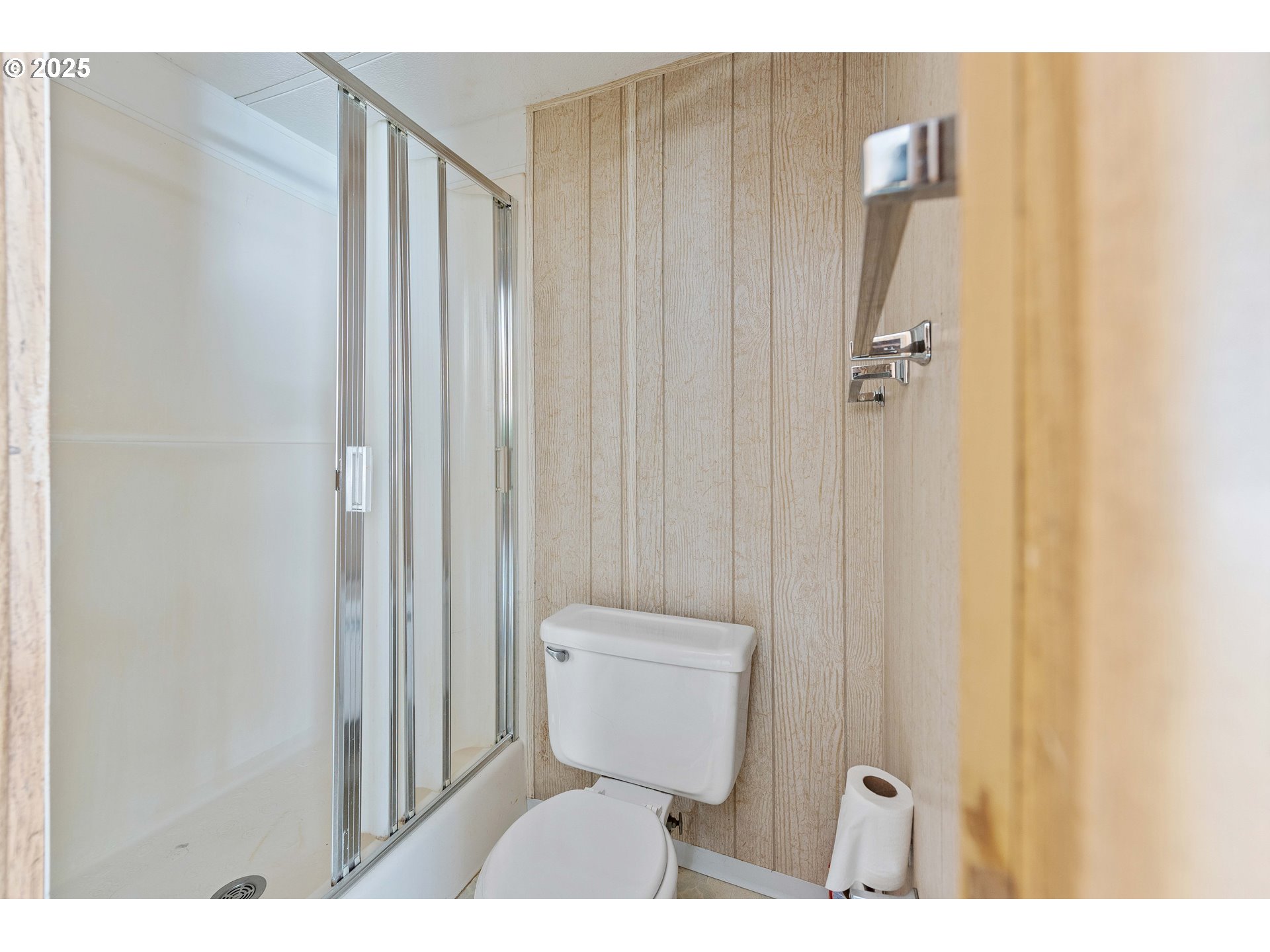 1413 Hawthorne Avenue, Unit 31 Reedsport, OR 97467 - Photo 11 of 16 a bathroom with a toilet and a shower curtain