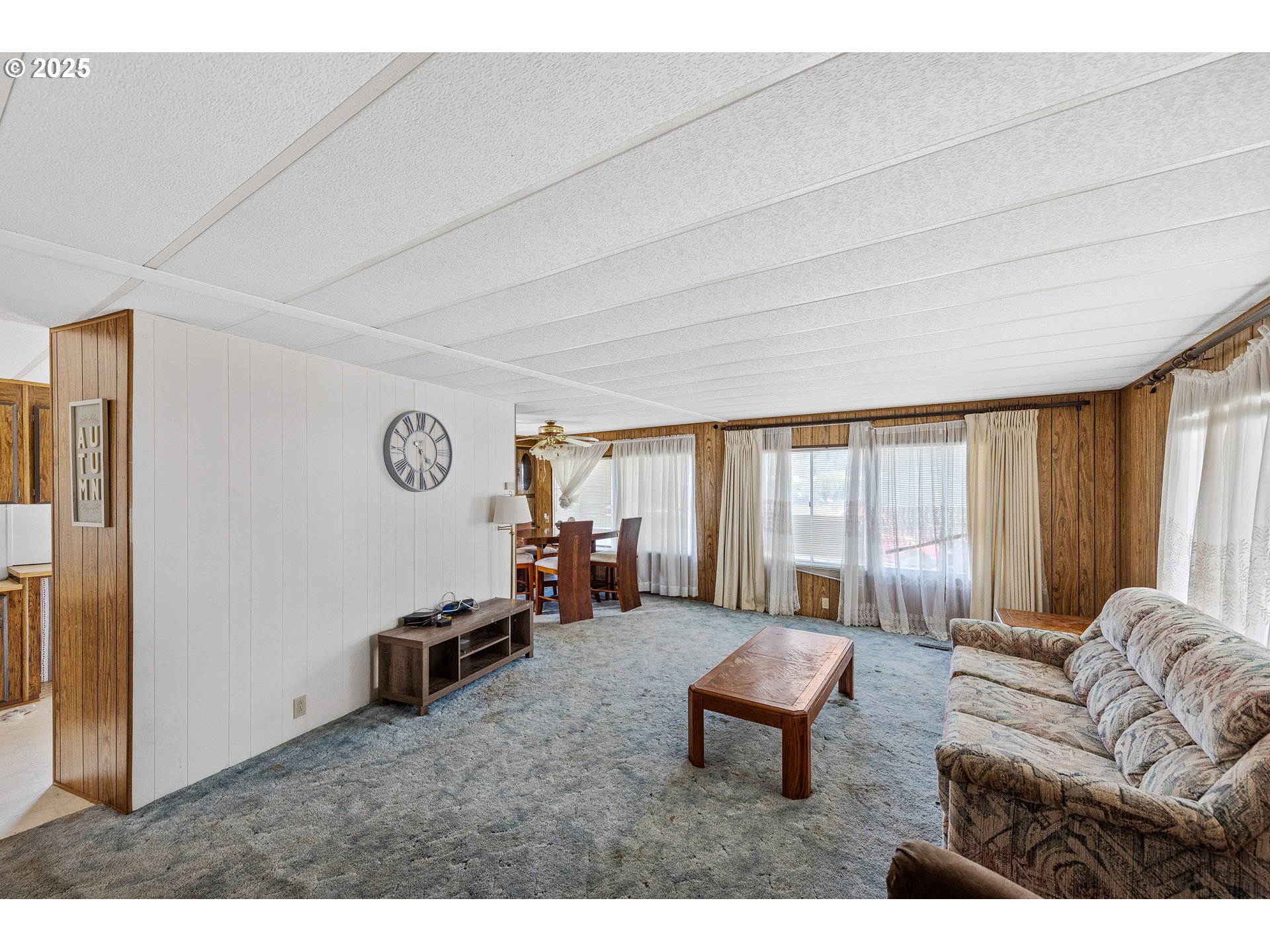 1413 Hawthorne Avenue, Unit 31 Reedsport, OR 97467 - Photo 2 of 16 a living room with furniture a large window and a chandelier