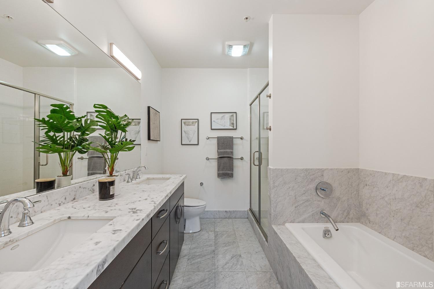 741 Clement Street, Unit 202 San Francisco, CA 94118 - Photo 14 of 23 a bathroom with a granite countertop sink a mirror and a bathtub