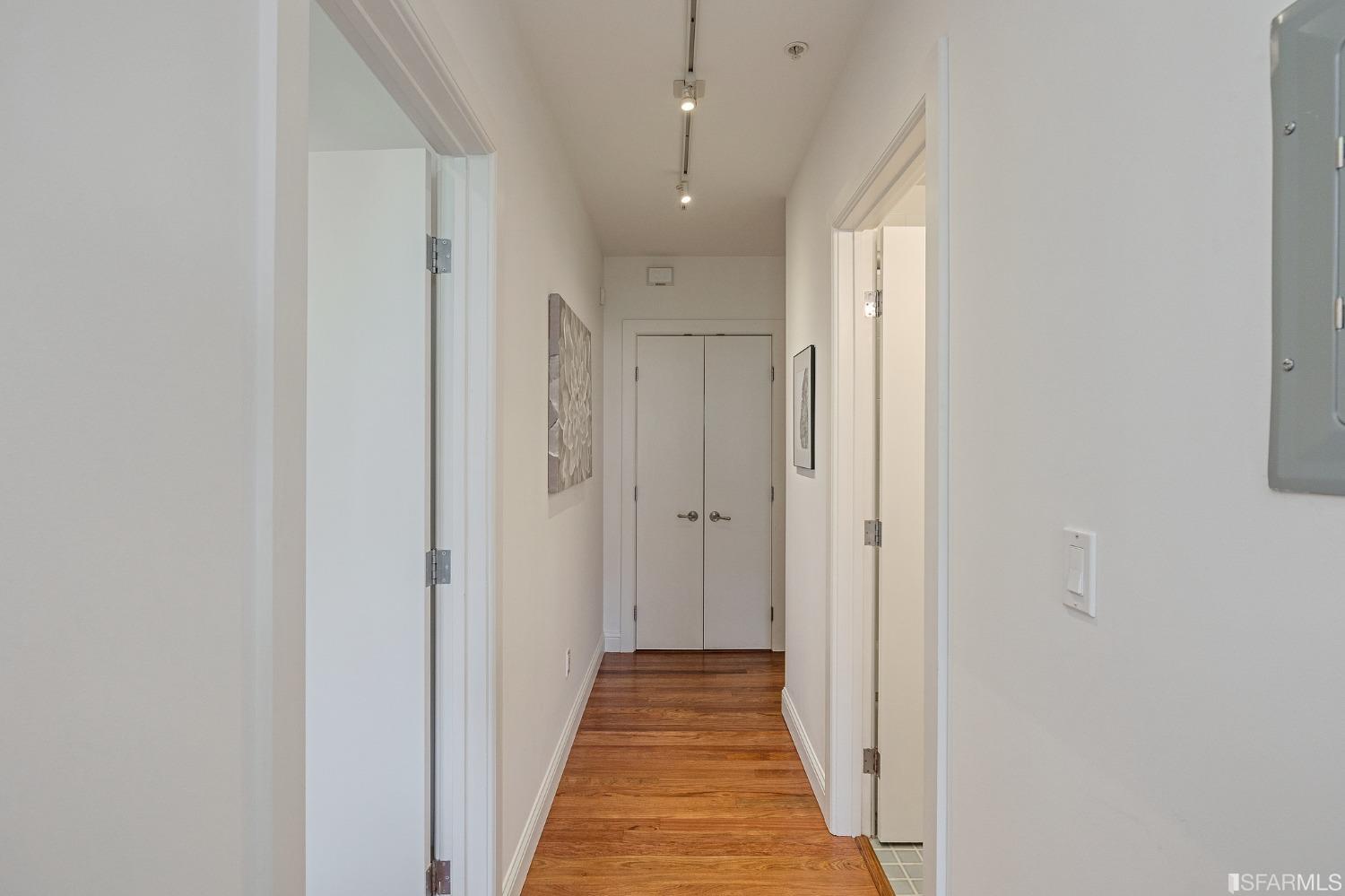 741 Clement Street, Unit 202 San Francisco, CA 94118 - Photo 16 of 23 a view of a hallway with wooden floor and a bathroom