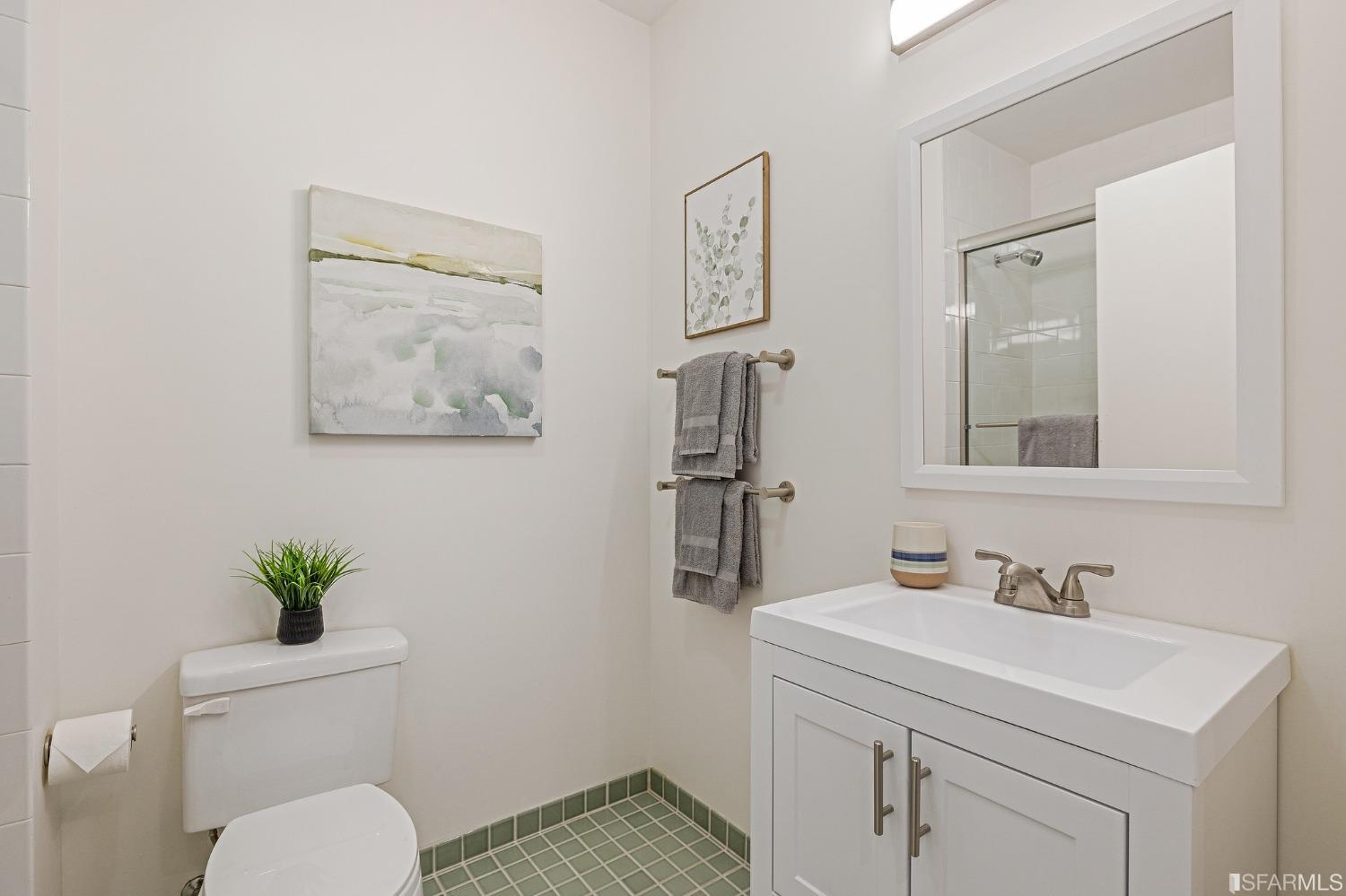 741 Clement Street, Unit 202 San Francisco, CA 94118 - Photo 17 of 23 a bathroom with a toilet a sink and a mirror