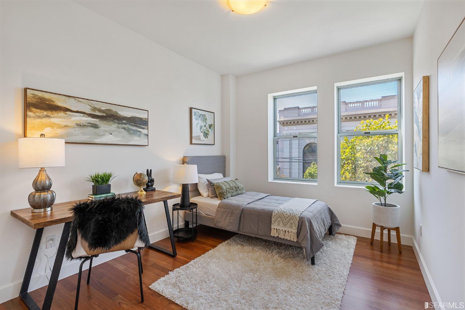 741 Clement Street, Unit 202 San Francisco, CA 94118 - Photo 18 of 23 a bedroom with a bed and wooden floor