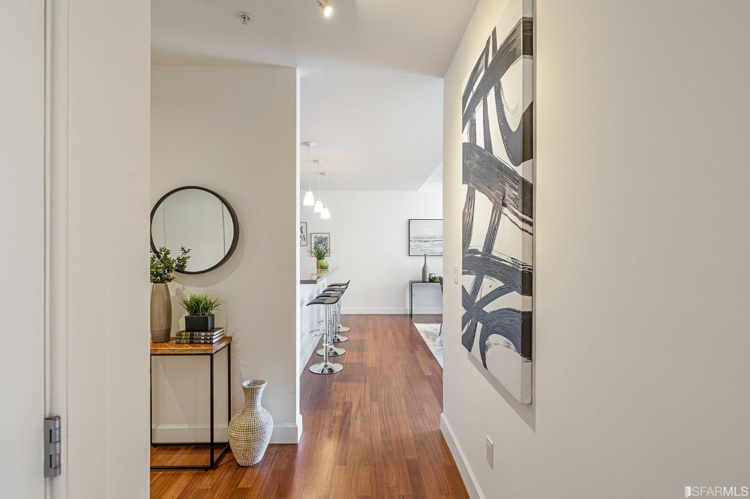 741 Clement Street, Unit 202 San Francisco, CA 94118 - Photo 20 of 23 a view of a hallway with furniture and wooden floor