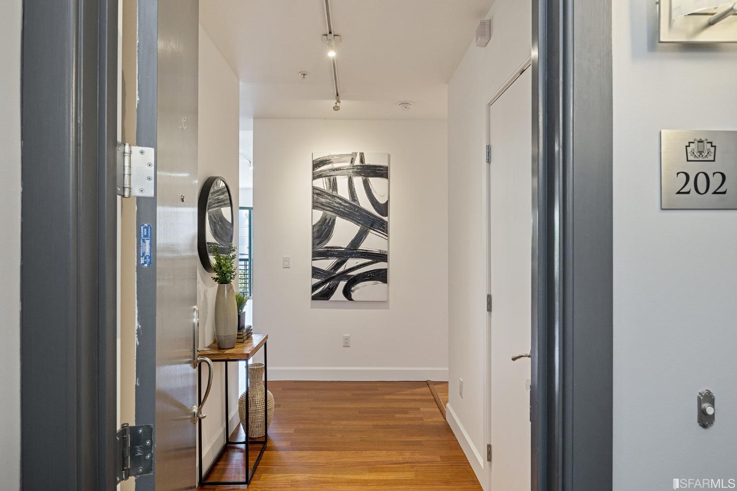 741 Clement Street, Unit 202 San Francisco, CA 94118 - Photo 2 of 23 a view of a hallway with wooden floor and entryway