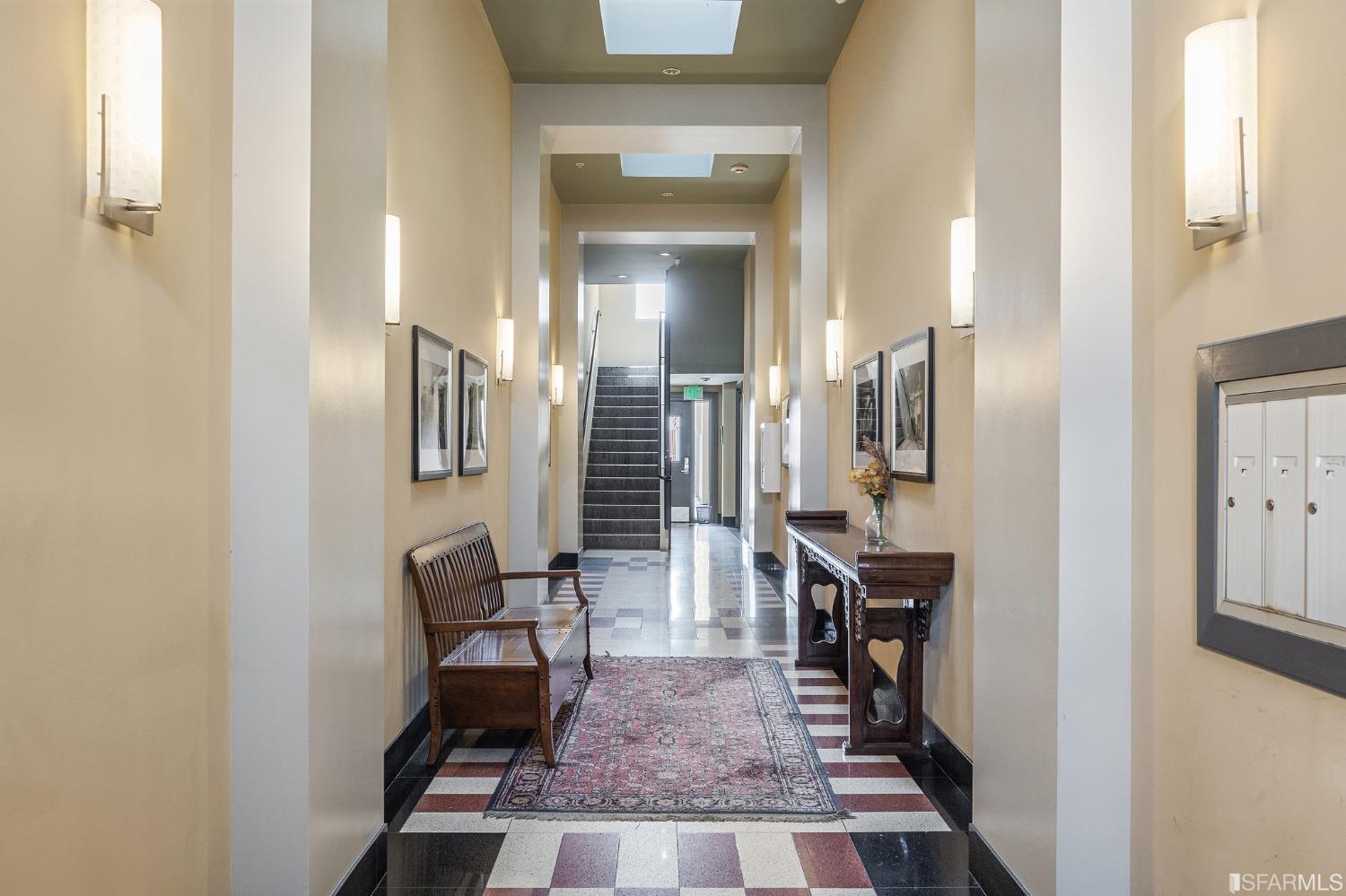 741 Clement Street, Unit 202 San Francisco, CA 94118 - Photo 22 of 23 a view of a hallway with wooden floor and a living room