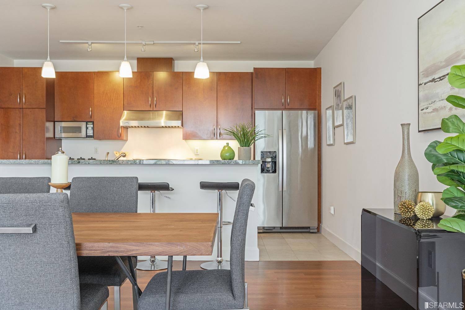 741 Clement Street, Unit 202 San Francisco, CA 94118 - Photo 8 of 23 a kitchen with stainless steel appliances granite countertop wooden floor a refrigerator and a stove