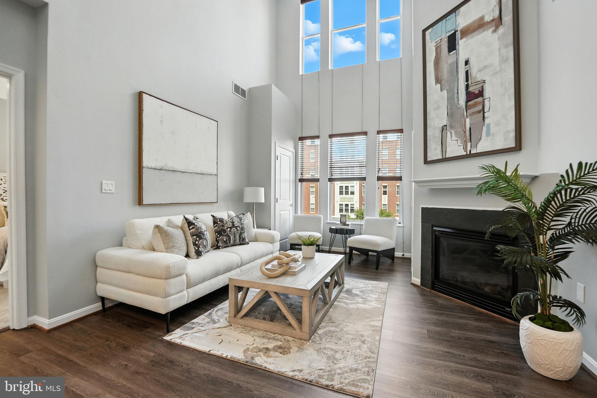 a living room with furniture potted plant and a window