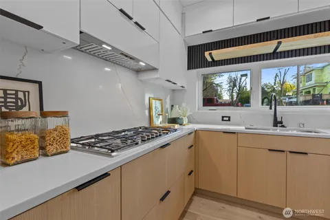 a kitchen with stainless steel appliances a sink a stove and a refrigerator