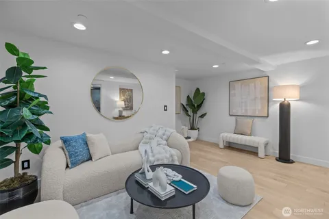 a living room with furniture potted plant and a lamp