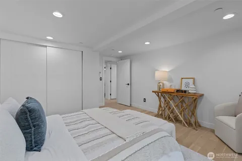 a bed room with a bed and a chair