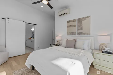 a bedroom with a bed and a chandelier