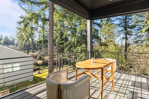 a view of yard with swimming pool and seating