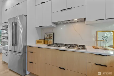 a kitchen with stainless steel appliances granite countertop a refrigerator and a sink