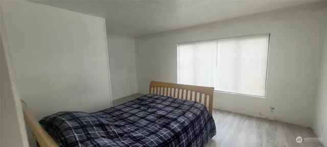 a bedroom with a bed and a window