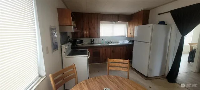 an empty room with wooden floor and entrance