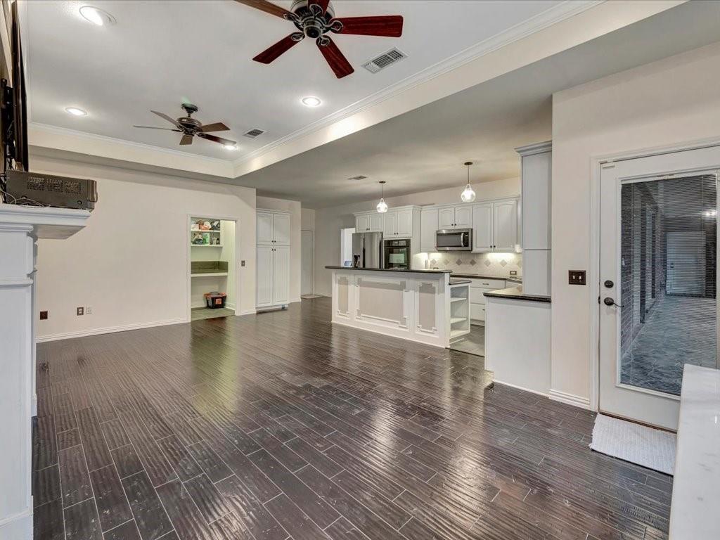 206 Cascade Court Lufkin, TX 75901 - Photo 11 of 29 a view of a kitchen with a refrigerator a ceiling fan and wooden floor