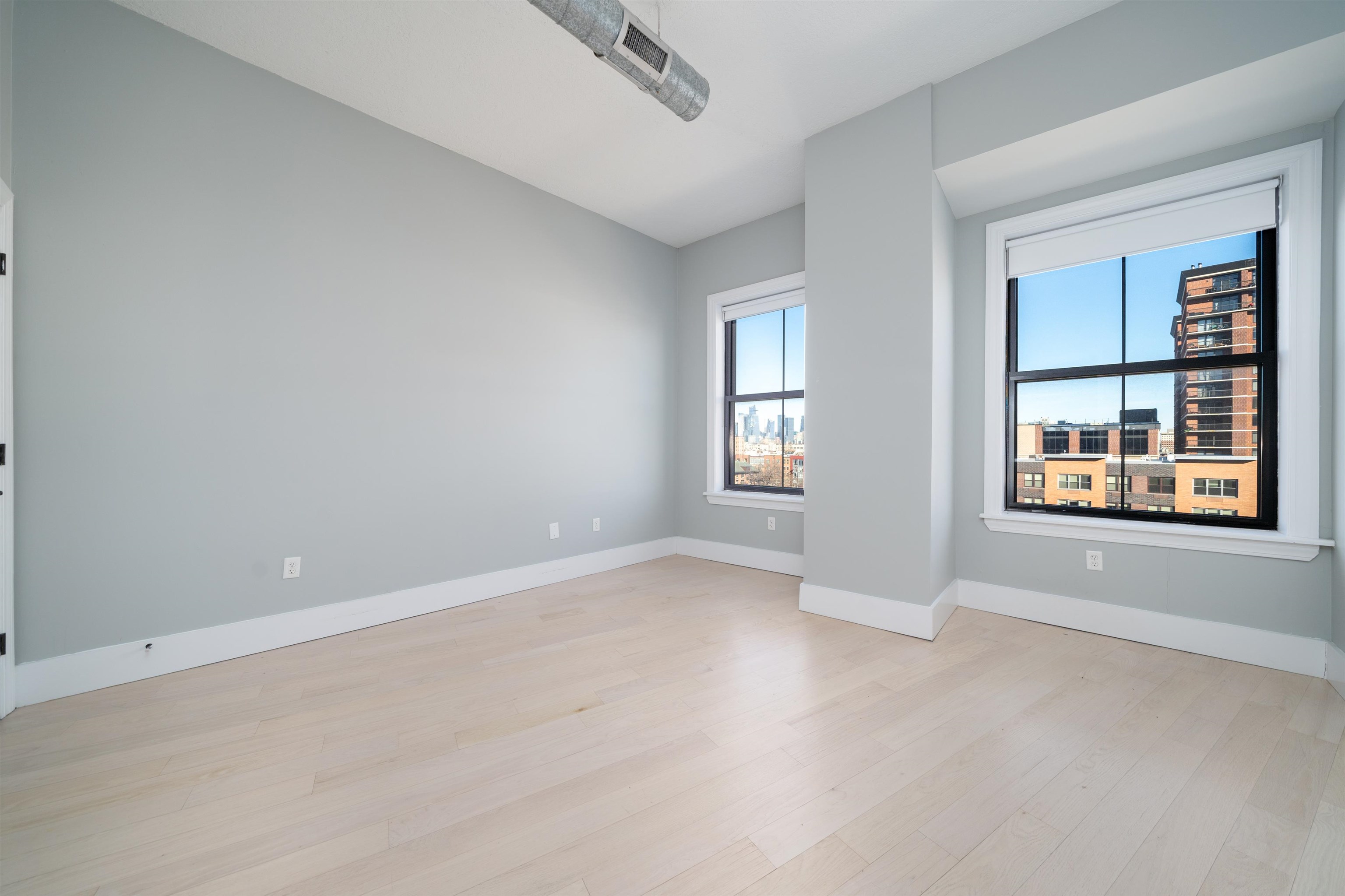 100 Paterson Plank Road, Unit 504 Jersey City, NJ 07307 - Photo 12 of 23 an empty room with windows