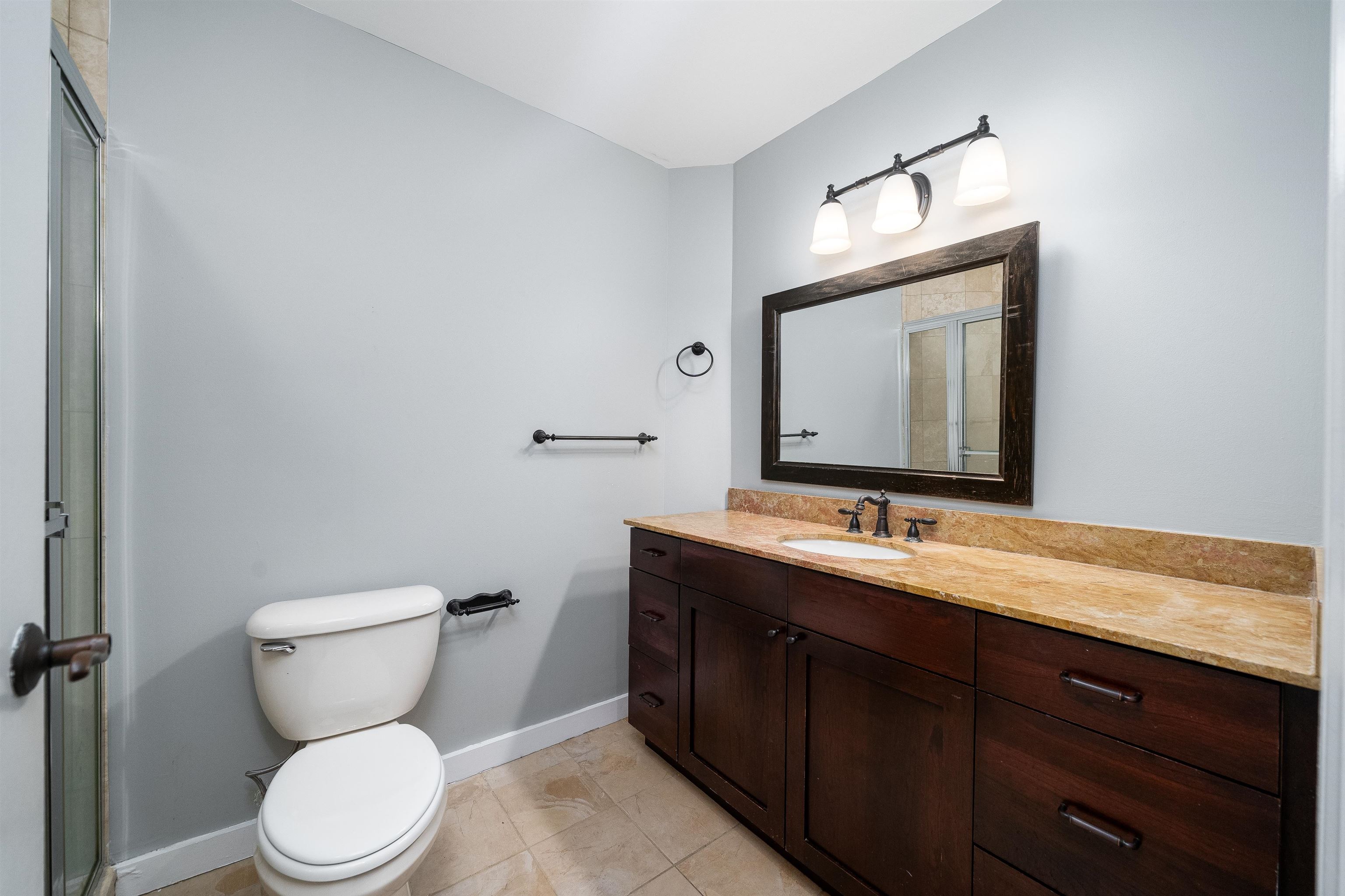 100 Paterson Plank Road, Unit 504 Jersey City, NJ 07307 - Photo 15 of 23 a bathroom with a toilet sink and mirror