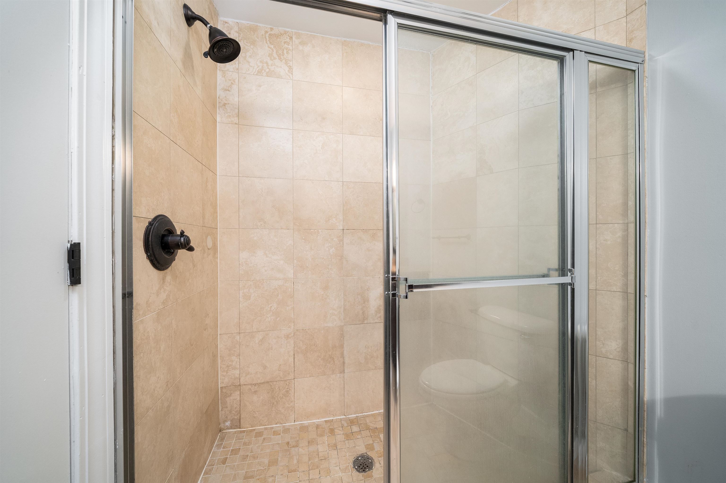 100 Paterson Plank Road, Unit 504 Jersey City, NJ 07307 - Photo 16 of 23 a bathroom with a glass shower door
