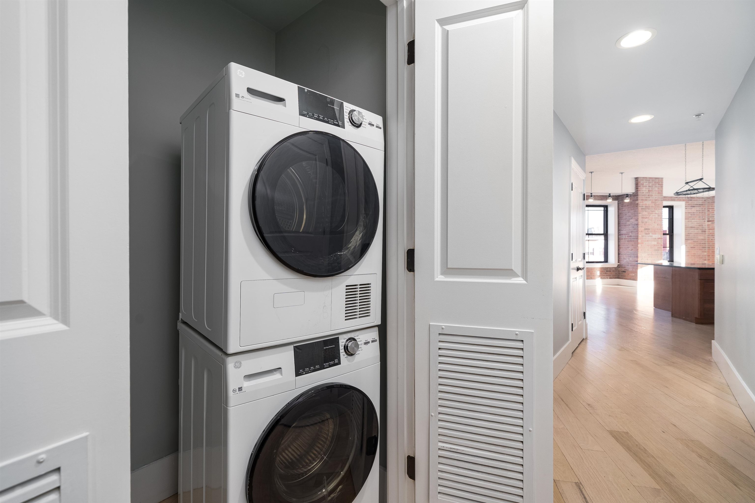100 Paterson Plank Road, Unit 504 Jersey City, NJ 07307 - Photo 17 of 23 a view of a hallway with washer and dryer