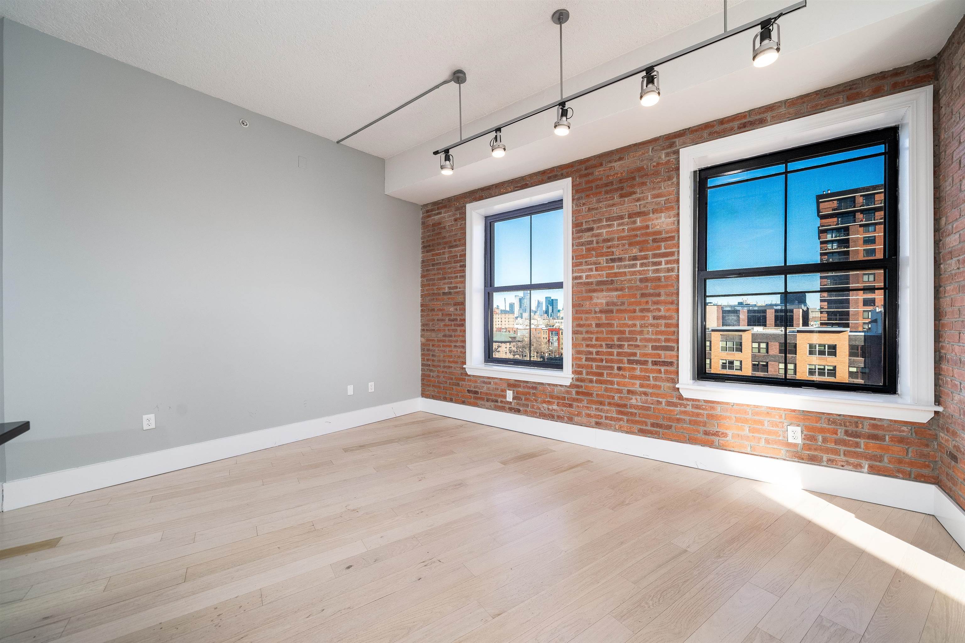 100 Paterson Plank Road, Unit 504 Jersey City, NJ 07307 - Photo 6 of 23 a view of an empty room with a window and fireplace