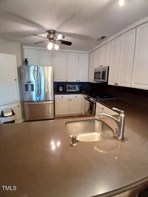 631 Springfork Drive Cary, NC 27513 - Photo 12 of 23 a kitchen with a sink and a refrigerator