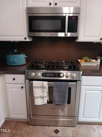 a stove top oven sitting inside of a kitchen