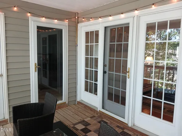 a view of front door and porch with wooden floor