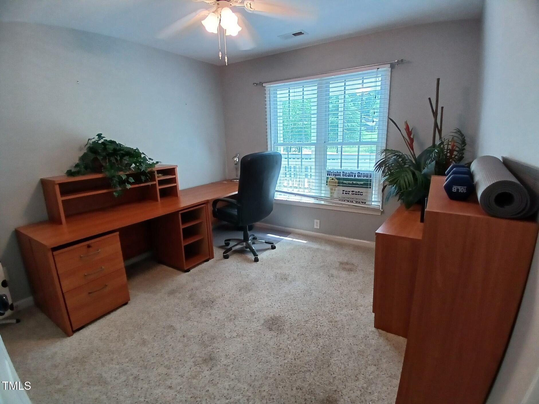 631 Springfork Drive Cary, NC 27513 - Photo 23 of 23 a work room with furniture and a potted plant