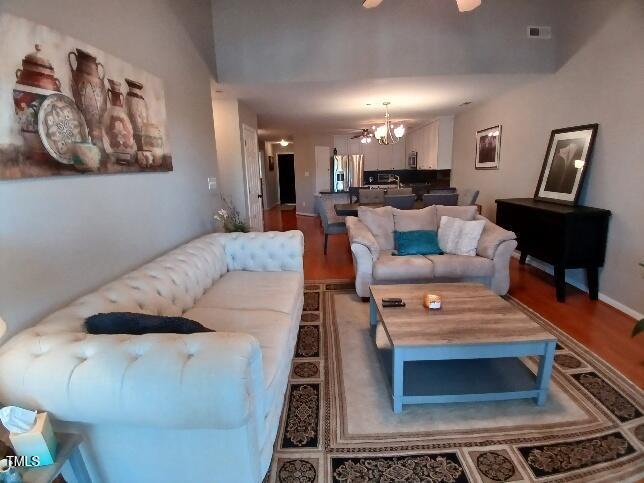 631 Springfork Drive Cary, NC 27513 - Photo 8 of 23 a living room with furniture and a wooden floor