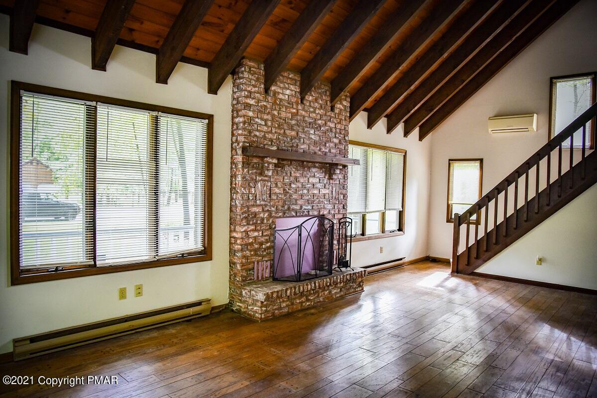 2202 Delaware Court East Bushkill, PA 18324 - Photo 11 of 18 a view of an empty room with wooden floor and a window