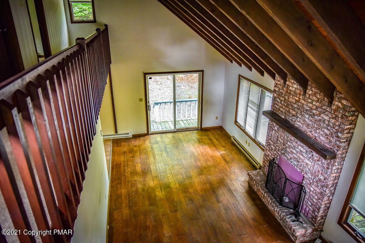 2202 Delaware Court East Bushkill, PA 18324 - Photo 12 of 18 a view of an empty room with wooden floor and a window