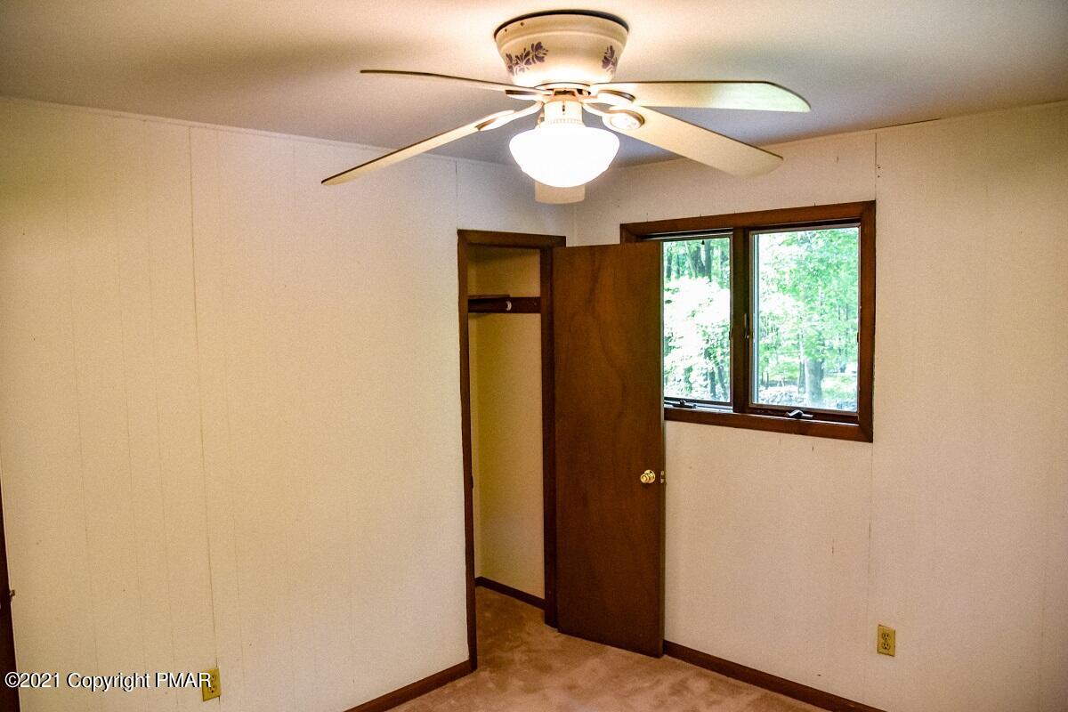 2202 Delaware Court East Bushkill, PA 18324 - Photo 14 of 18 a view of a livingroom with a window and a ceiling fan