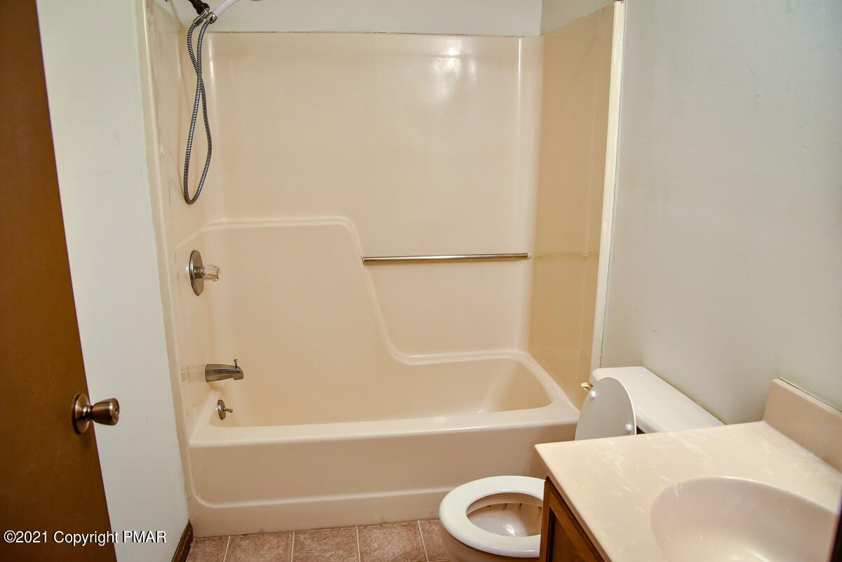 2202 Delaware Court East Bushkill, PA 18324 - Photo 15 of 18 a bathroom with a shower and a toilet
