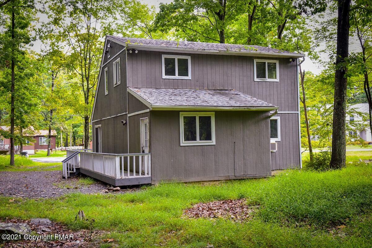 2202 Delaware Court East Bushkill, PA 18324 - Photo 18 of 18 a view of backyard of house with wooden fence and large trees