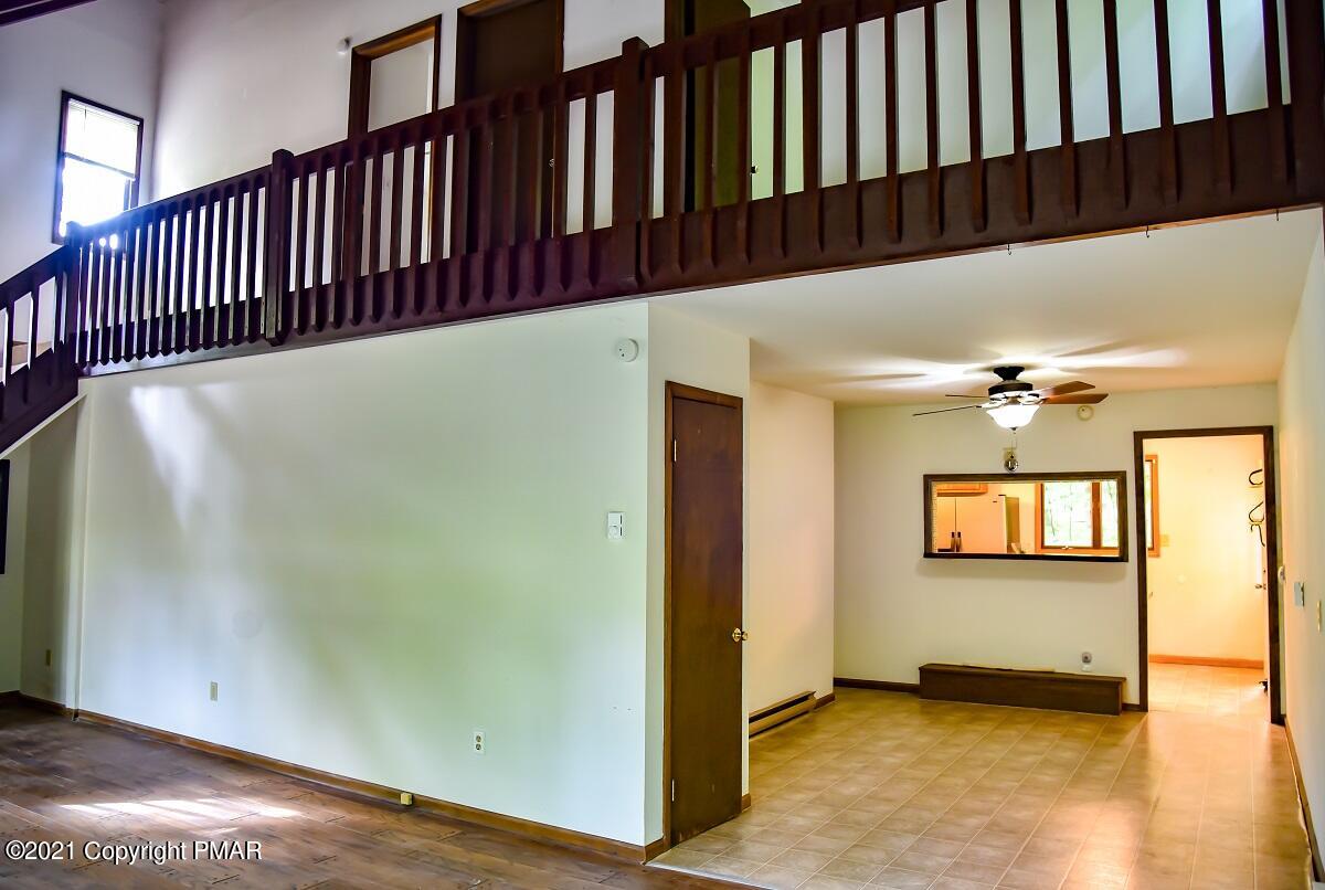 2202 Delaware Court East Bushkill, PA 18324 - Photo 8 of 18 a view of a hallway with wooden floor and staircase