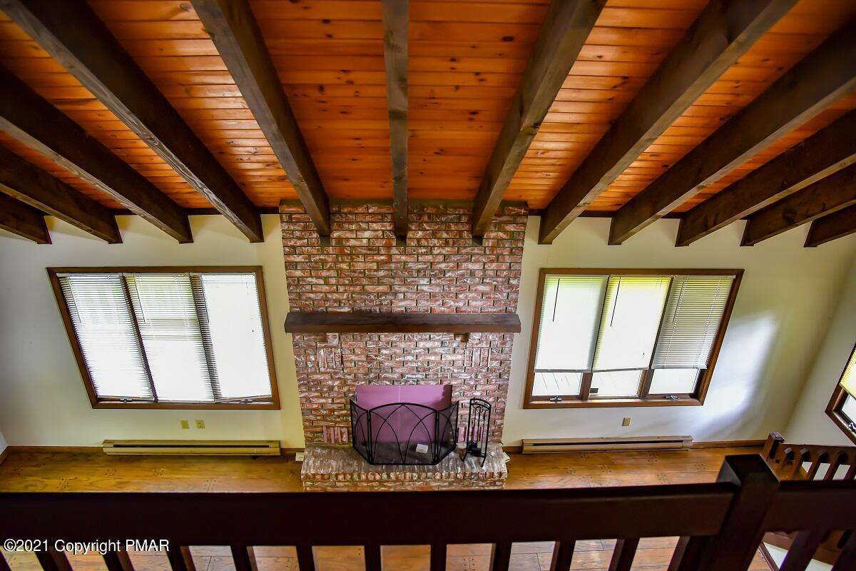 2202 Delaware Court East Bushkill, PA 18324 - Photo 9 of 18 a view of an empty room with a fireplace and a window