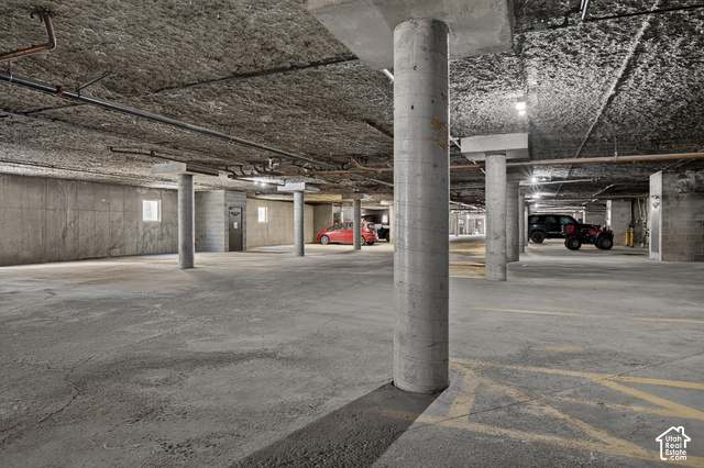 150 Ridgeview Street Brian Head, UT 84719 - Photo 23 of 43 Concrete parking structure featuring exposed aggregate ceiling, concrete support columns, and overhead lighting