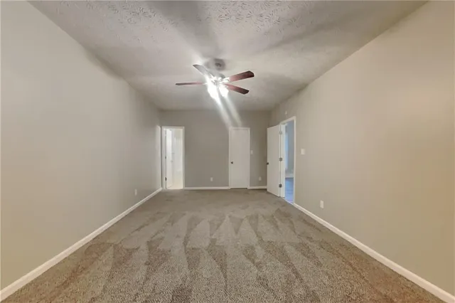 a view of an empty room with a ceiling fan