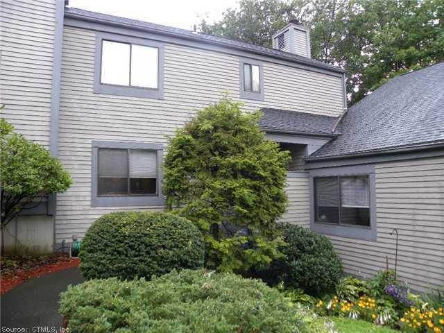 512 Pilgrims Harbor, Unit 512 Wallingford, CT 06492 - Photo 1 of 1 a front view of a house with a yard