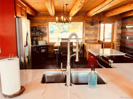 a kitchen with stainless steel appliances kitchen island granite countertop a refrigerator and a sink