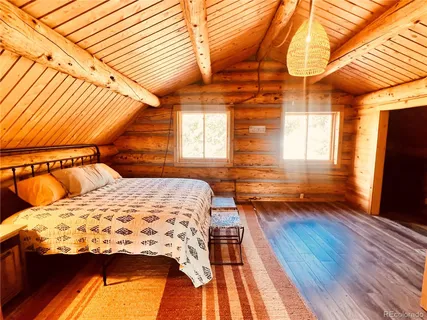 a bedroom with a bed and a flat tv screen