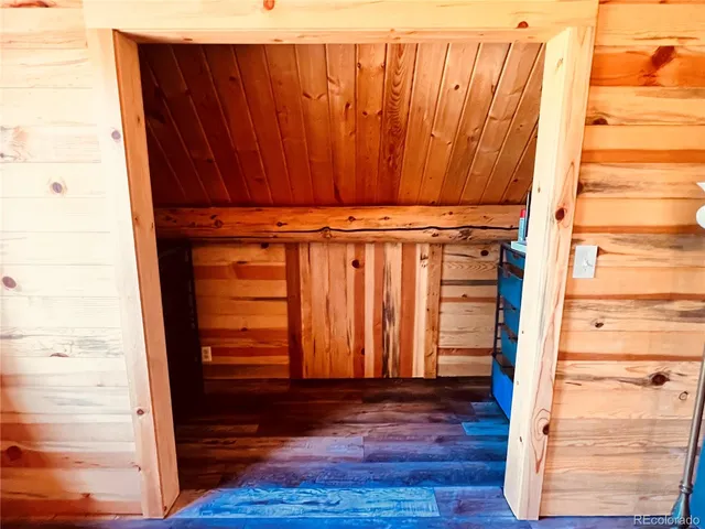 a view of walk in closet with wooden floor