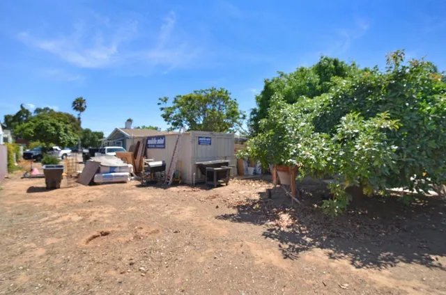 a view of a house with a yard and sitting area