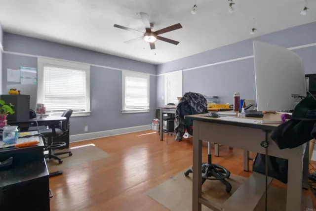 a view of a workspace with furniture and a window
