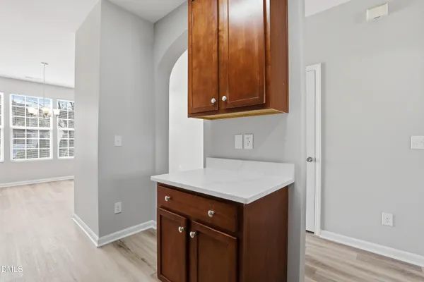 a room with a sink cabinets and a wooden floor