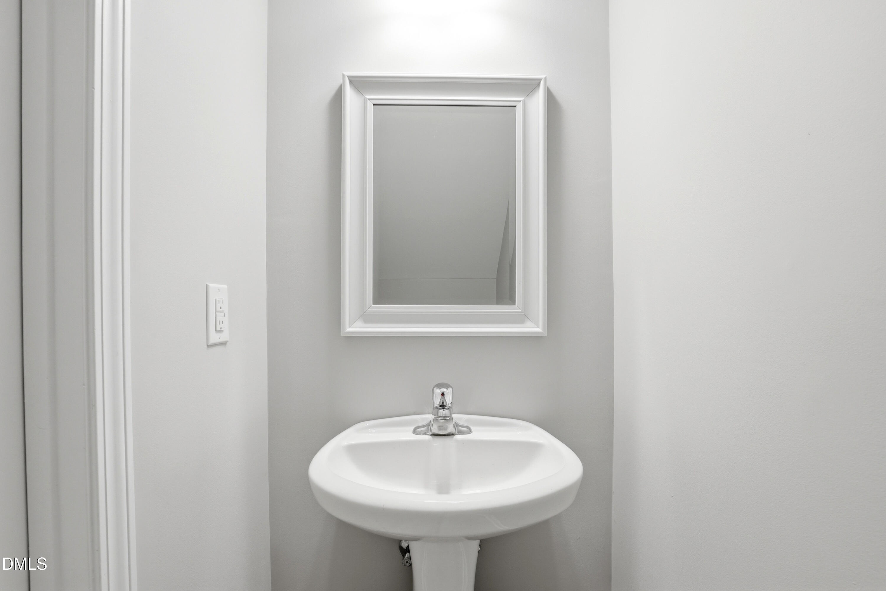 715 Bryant Street Raleigh, NC 27603 - Photo 13 of 25 a bathroom with a sink and a mirror