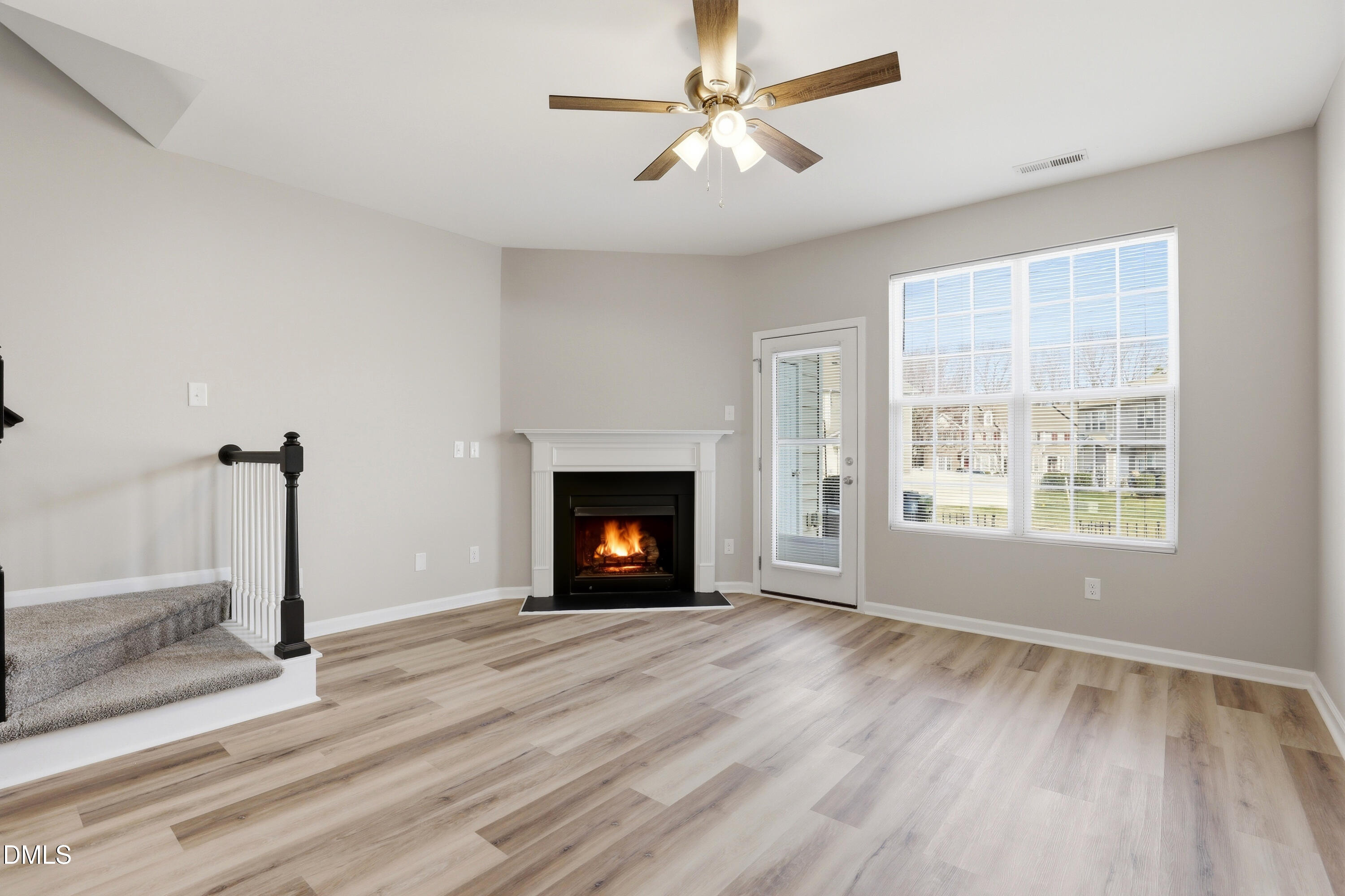 715 Bryant Street Raleigh, NC 27603 - Photo 15 of 25 a view of empty room with a fireplace and wooden floor