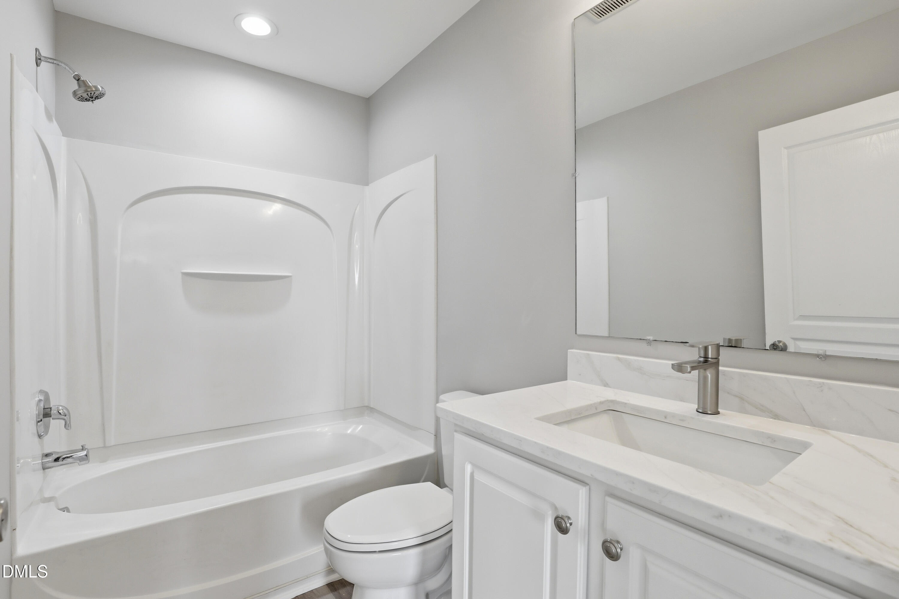 715 Bryant Street Raleigh, NC 27603 - Photo 20 of 25 a bathroom with a granite countertop sink a toilet and shower