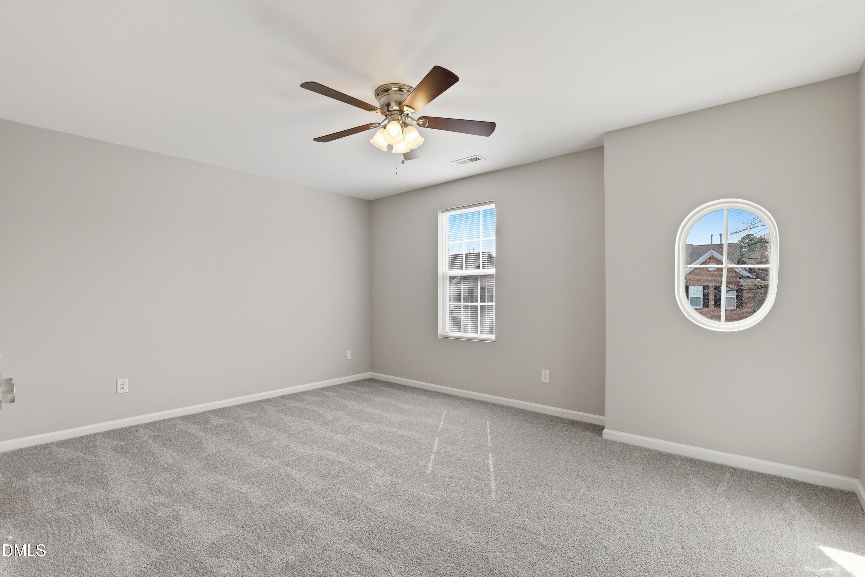 715 Bryant Street Raleigh, NC 27603 - Photo 22 of 25 an empty room with windows and fan